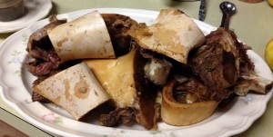 Marrow bones and bones with meat go on a platter.