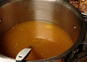 I rinse out my stock pots and if I am feeling particularly obsessive, I will strain the broth again into the stock pot from the work bowl. It usually is not necessary. 