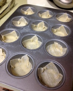 Tuck one wonton wrapper into each muffin cup.